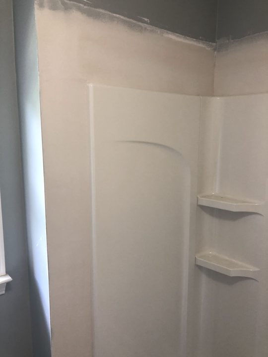 After: Wall opened at a tub surround, closed up and finished