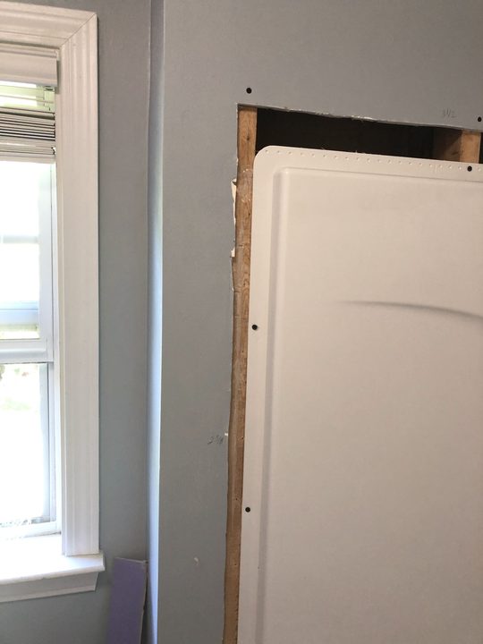 Before: Wall opened at a tub surround, closed up and finished