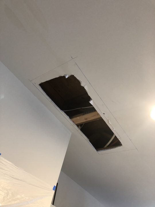 Before: Ceiling cut open to fix a leak, then patched and finished
