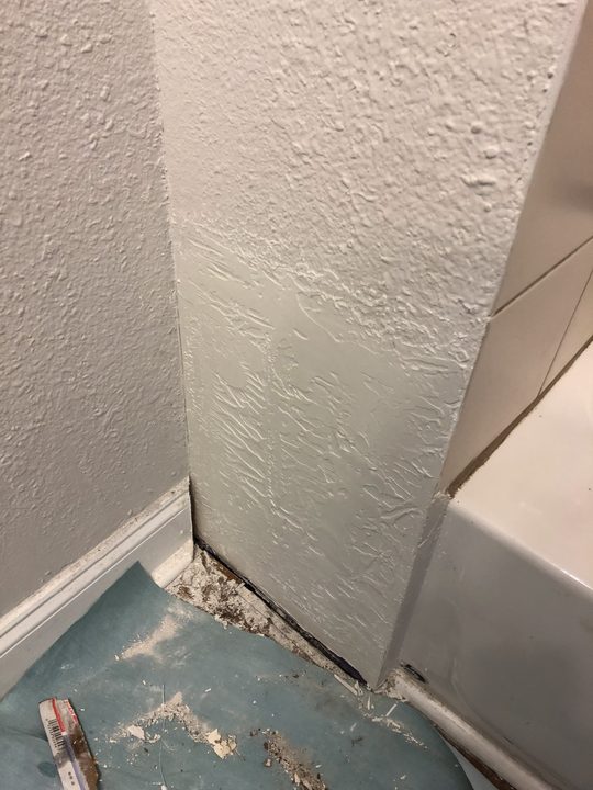After: Textured wall torn out at the base, repaired and texture matched